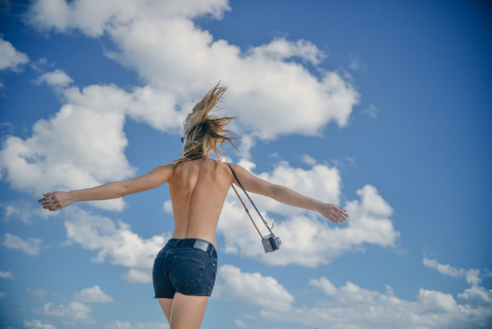 a topless girl with hairless skin